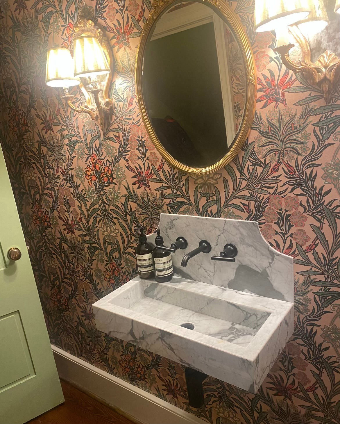 Small powder room sink installed showcasing unique bathroom trends