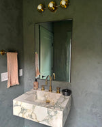 Calacatta viola marble sink shown as a floating marble sink and marble vessel sink in a modern bathroom setting