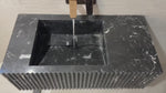 Video showcasing a handcrafted black marble sink with fluted design and custom dimensions, perfect for luxury bathroom vanities.